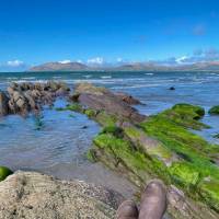 Sitting beside a lake with hills in the distance